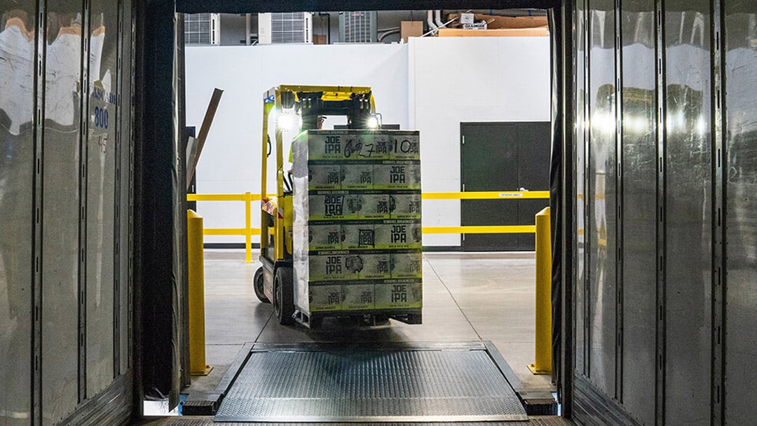 A pallet of several shipped packages on a forklift.