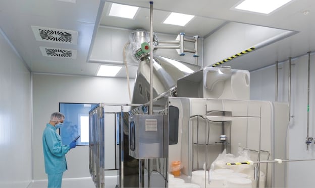 Someone in a cleanroom where food ingredients are being stored and monitored.