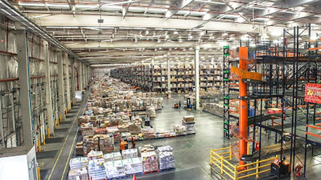 A warehouse with shelves full of product waiting to be picked and packed for customer order fulfillment.